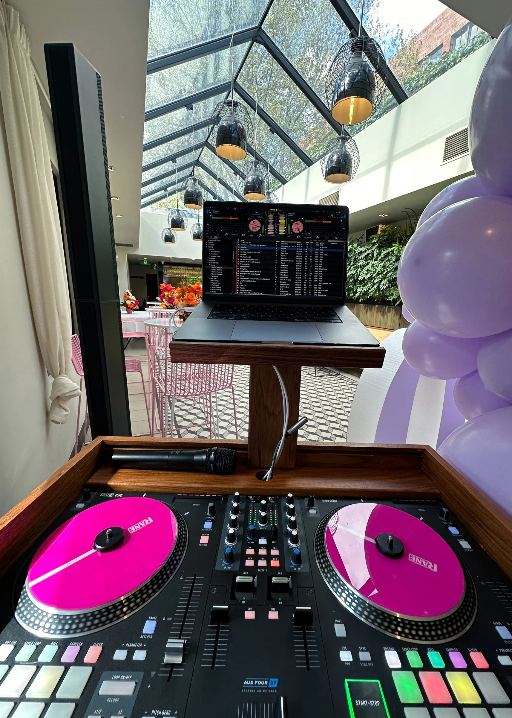 Dan’s decks with magenta platters spinning on the turntables